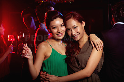 Buy stock photo Portrait of two young woman enjoying themselves in a nightclub