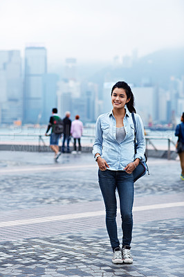 Buy stock photo Portrait of an attractive young asian woman standing in front of the Hong Kong skyline