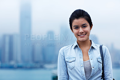 Buy stock photo Portrait of a young asian woman in front of the Hong Kong skyline
