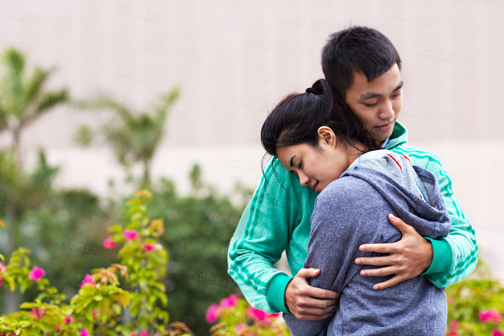 Buy stock photo Dating, hug and Asian couple in city for love, affection or bonding on weekend together. Travel, support and man with woman embrace for relationship, connection or trust on holiday, vacation or break