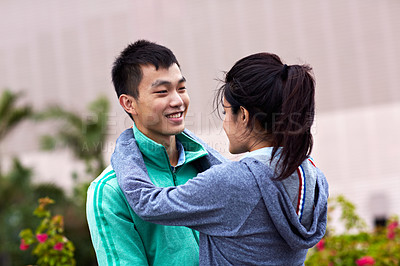 Buy stock photo Shot of an affectionate young asian couple hugging