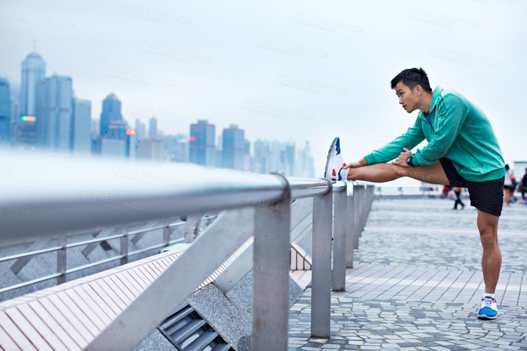 Buy stock photo Stretching, legs and Asian man on bridge for fitness, workout and ready for runner challenge. Sports, city and person warm up for training, wellness and active for health and exercise in Hong Kong