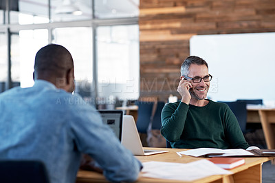 Buy stock photo Shot of a designer talking on his cellphone
