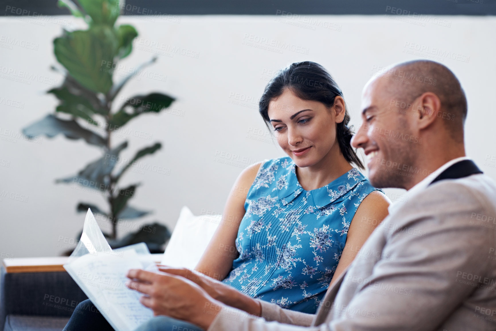 Buy stock photo Shot of two coworkers discussing paperwork in a modern office