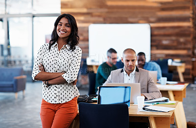 Buy stock photo Portrait of a young designer with her colleagues blurred in the background