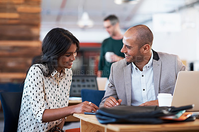 Buy stock photo Shot of two colleagues having a discussion at a desk