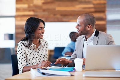 Buy stock photo Shot of two colleagues having a discussion at a desk