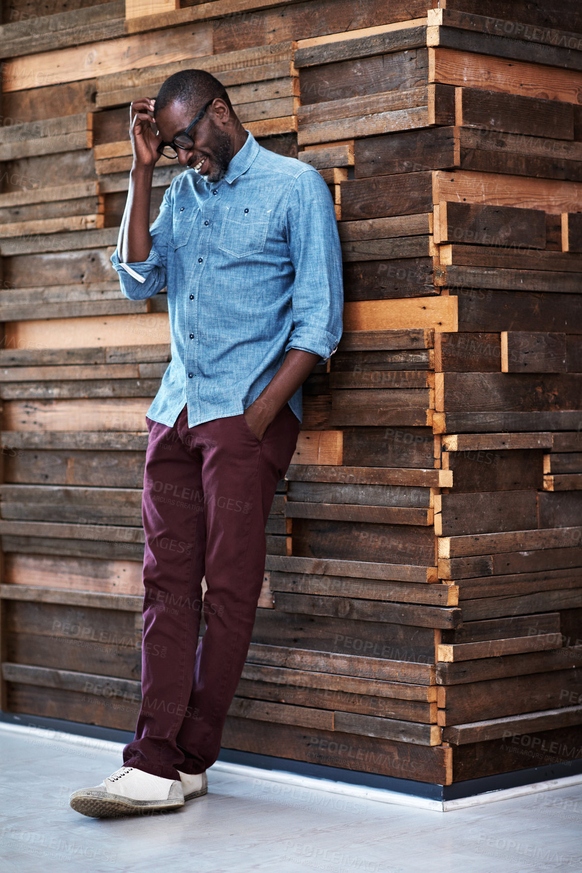 Buy stock photo Shot of a designer leaning against a wooden wall