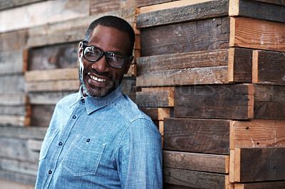 Buy stock photo Portrait of a designer leaning against a wooden wall