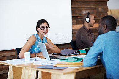 Buy stock photo Shot of designers having a discussion at a desk