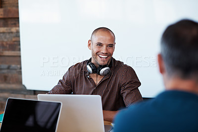 Buy stock photo Shot of two coworkers having a discussion at their desk