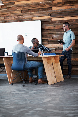 Buy stock photo Shot of a group of colleagues having a discussion in an office