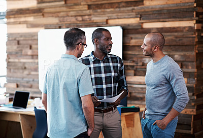 Buy stock photo Shot of a group of colleagues having a discussion in an office