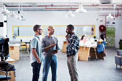 Buy stock photo Shot of a group of colleagues having a discussion in an office