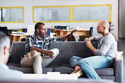 Buy stock photo Shot of two coworkers having a conversation in a modern office