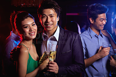 Buy stock photo Portrait of a young couple enjoying a night out together in a club