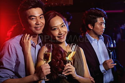 Buy stock photo Portrait of a young couple enjoying a night out together in a club