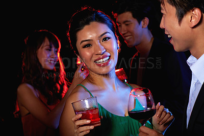 Buy stock photo Portrait of a young couple enjoying a night out together in a bar