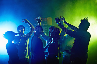 Buy stock photo Shot of a group of young asian people dancing together in a nightclub