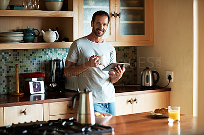 Buy stock photo Cropped shot of a handsome man eating breakfast while using a tablet