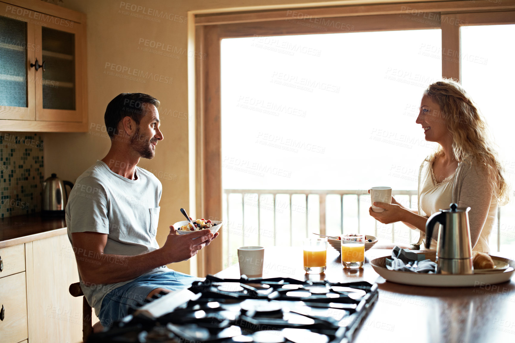 Buy stock photo Happy, couple and talk with coffee for breakfast bonding, healthy relationship and support. Food, mature people and conversation with drink in home for morning meal, marriage and love with fruit bowl