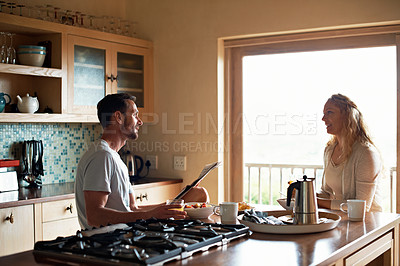 Buy stock photo Cropped shot of a couple having breakfast in the kitchen