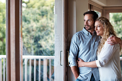 Buy stock photo Cropped shot of a couple looking out through a glass door of their home
