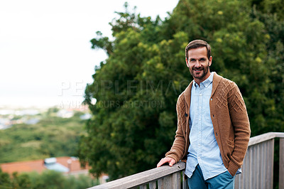 Buy stock photo Cropped shot of a handsome man standing outside on his deck