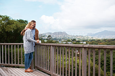Buy stock photo Full length shot of a couple talking outside on their deck