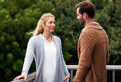 Buy stock photo Cropped shot of a couple talking outside on their deck