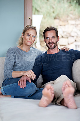 Buy stock photo Shot of a couple relaxing on their living room sofa
