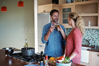 Buy stock photo Cropped shot of a couple cooking in the kitchen