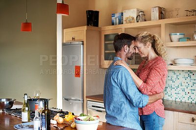Buy stock photo Cropped shot of a couple cooking in the kitchen
