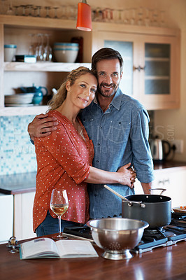 Buy stock photo Cropped shot of a couple cooking in the kitchen