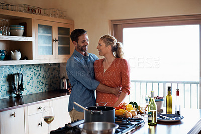 Buy stock photo Cropped shot of a couple cooking in the kitchen