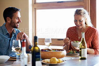 Buy stock photo Cropped shot of a couple having a romantic dinner at home