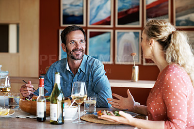 Buy stock photo Cropped shot of a couple having a romantic dinner at home
