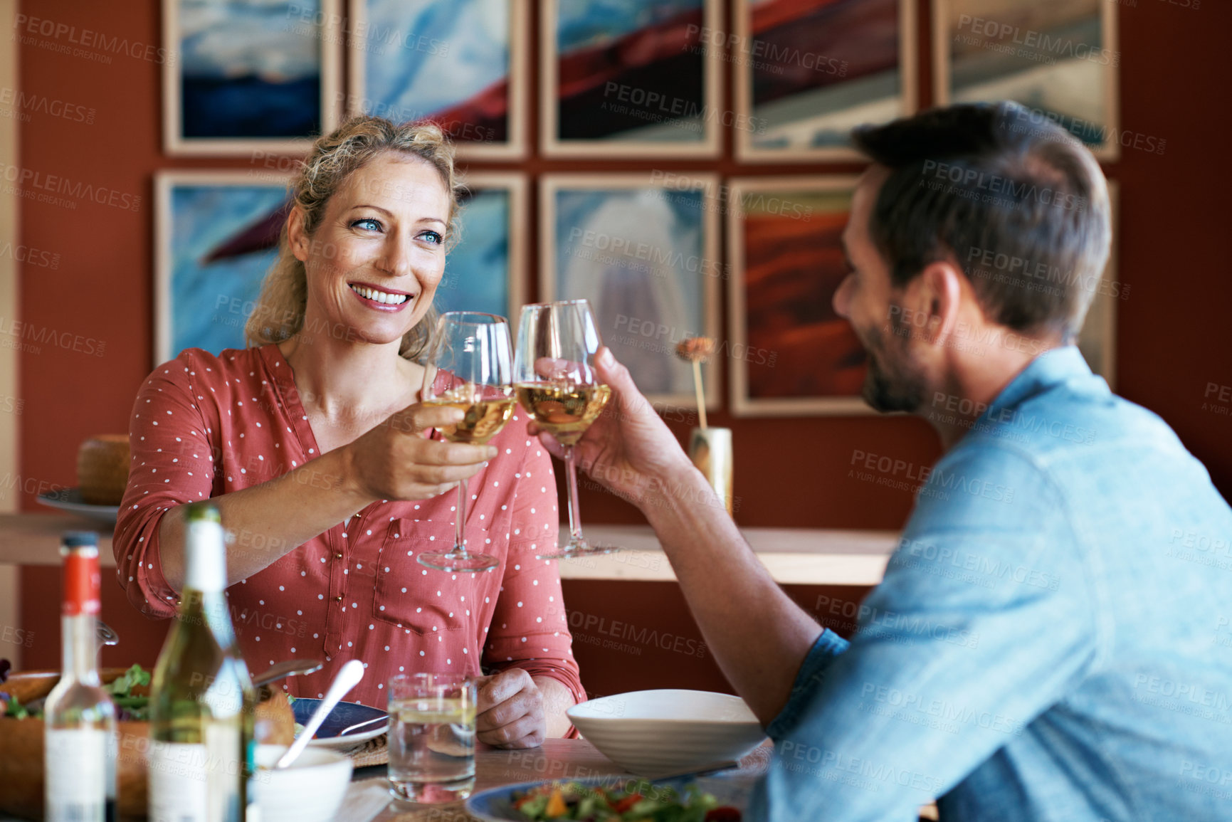 Buy stock photo Dinner, smile and couple with wine for cheers at house for bonding, celebration or date with food. Toast, happy and man with woman for eating meal with alcohol beverage for anniversary together.