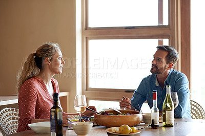 Buy stock photo Cropped shot of a couple having a romantic dinner at home