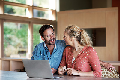 Buy stock photo Cropped shot of a couple using a laptop at home