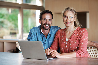 Buy stock photo Cropped shot of a couple using a laptop at home