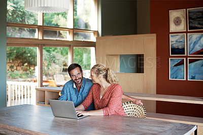 Buy stock photo Cropped shot of a couple using a laptop at home