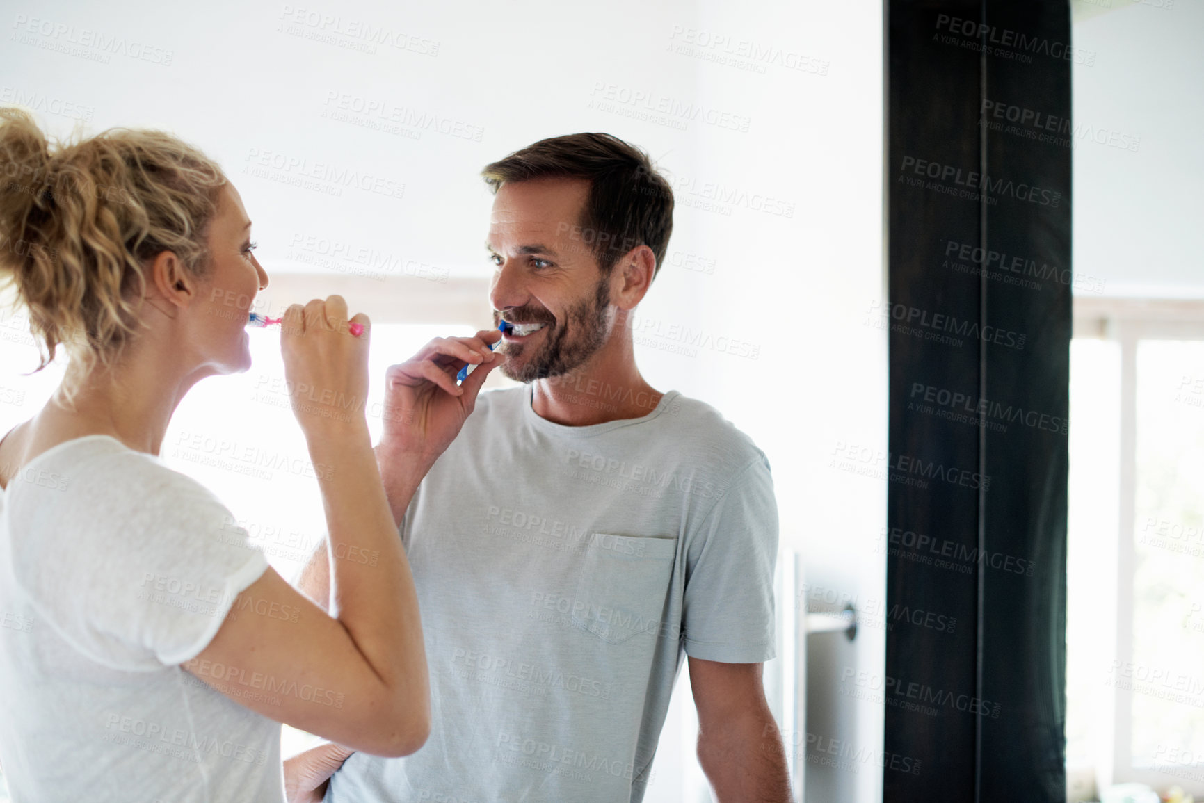 Buy stock photo Happy, morning and couple in bathroom for brushing teeth, hygiene and dental wellness together. Marriage, home and man with women with toothbrush for health, cleaning and bonding for daily routine