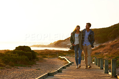 Buy stock photo Full length shot of an affectionate couple walking outdoors