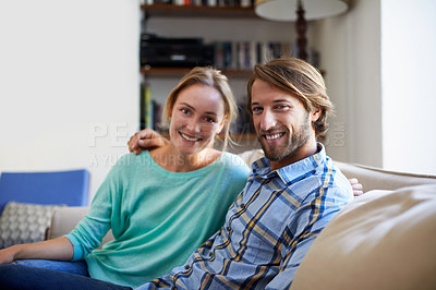 Buy stock photo Potrait of a young couple relaxing on a sofa at home