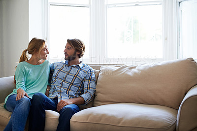 Buy stock photo Shot of a young couple relaxing on a sofa at home