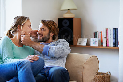 Buy stock photo Shot of a young couple relaxing on a sofa at home