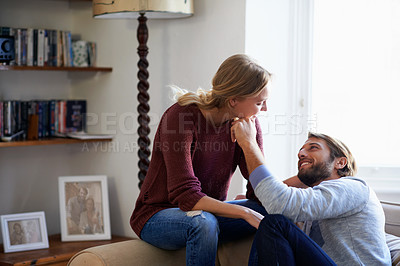 Buy stock photo Shot of a young couple relaxing on the sofa together at home