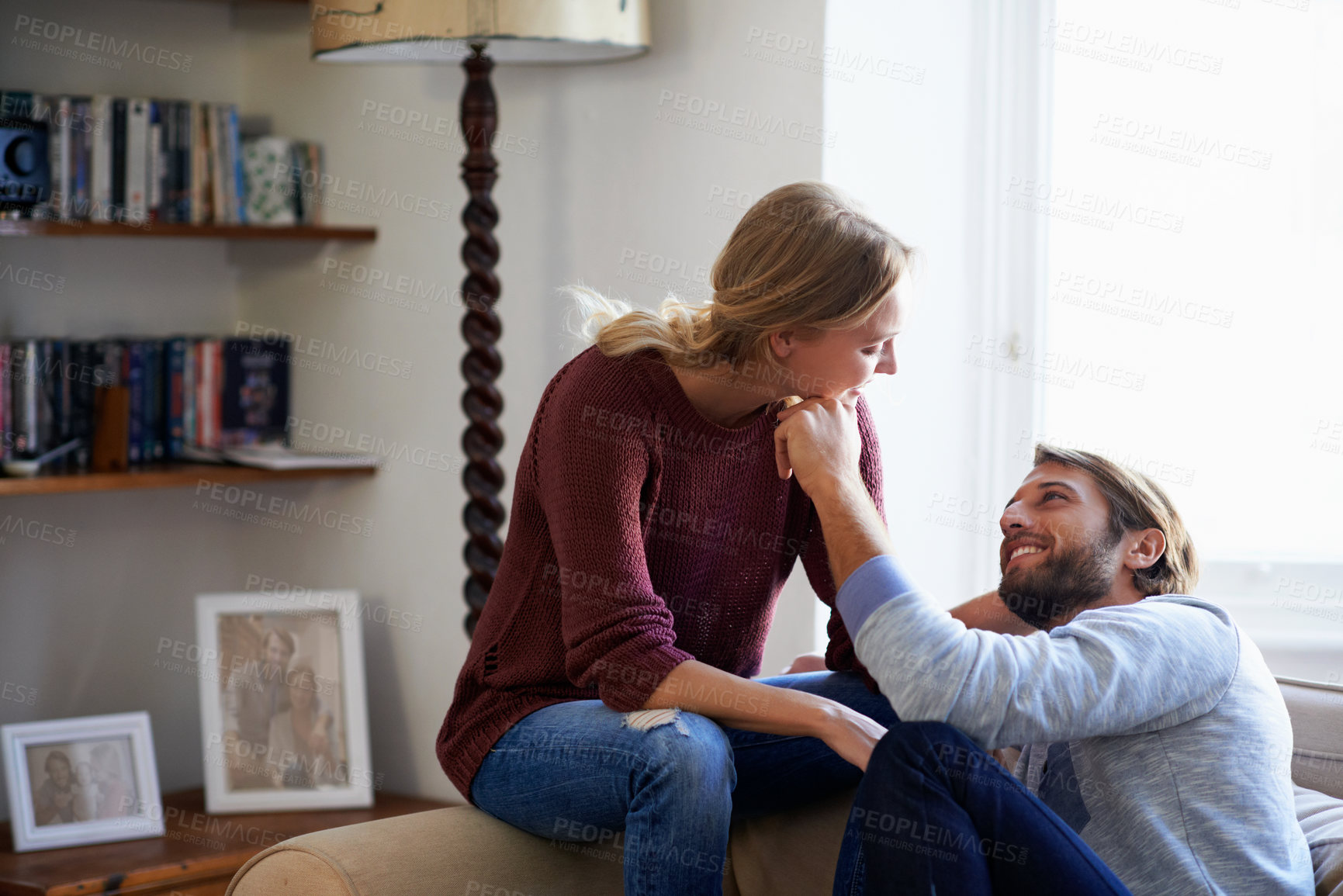Buy stock photo Couple, smile and romance on couch in house, love and relax with partner in living room and bonding. Happy people, care and connection with spouse in lounge, break and relationship commitment in home