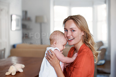 Buy stock photo Portrait of a young mother holding her baby at home